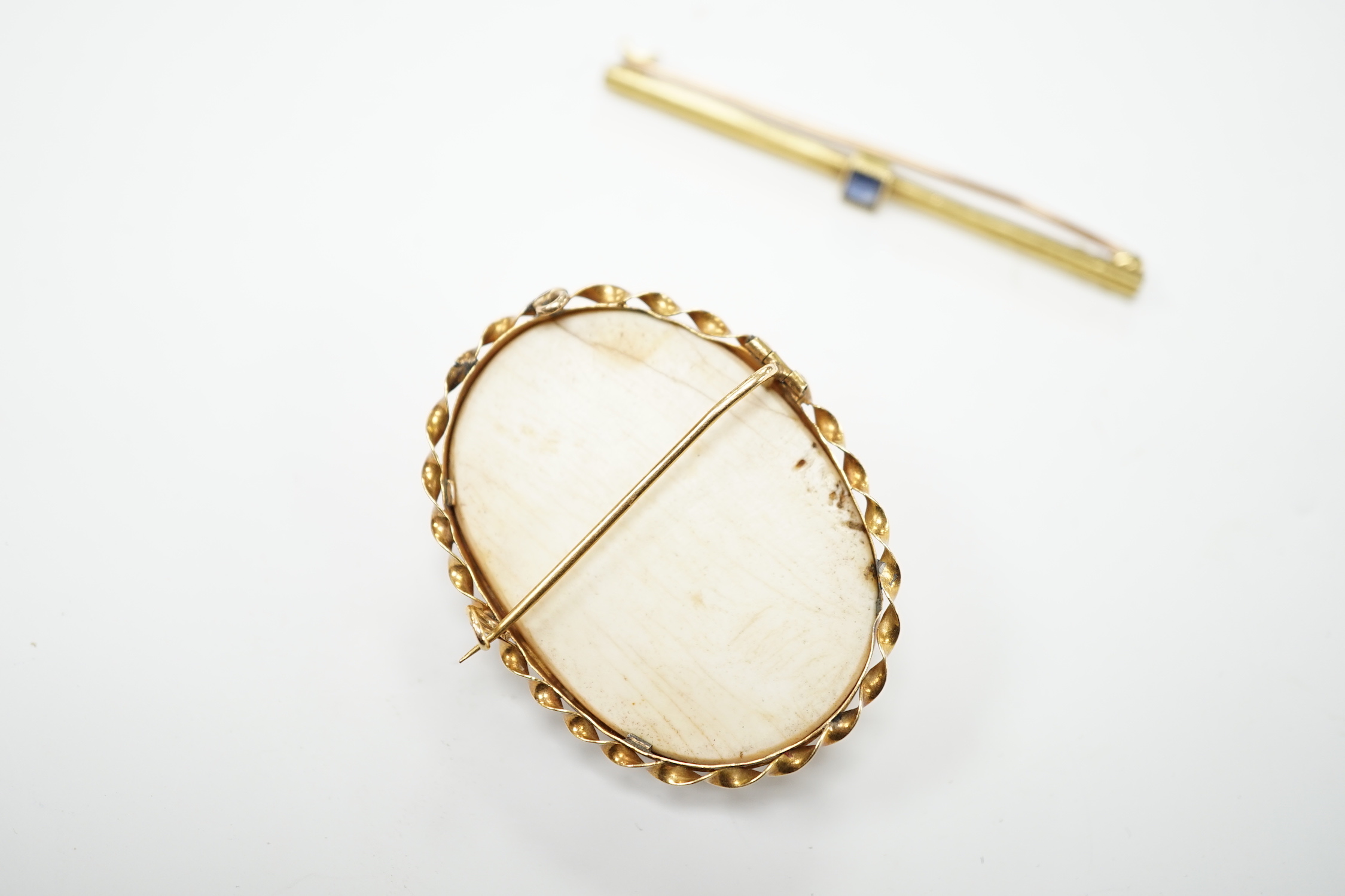 A yellow metal mounted composition cameo set oval brooch, 46mm, together with a yellow metal and gem set bar brooch.